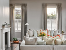 Double pleat curtains hanging from covered laths