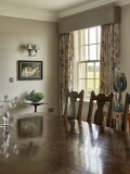 Floral curtains hanging from pelmet