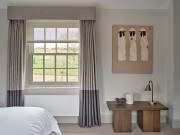 Curtains hanging from upholstered pelmet