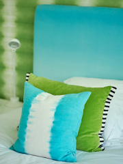 Designers Guild cushions with blue headboard