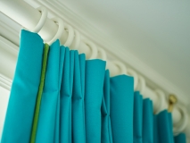 Designers Guild double pleat curtains with piping hanging from pole